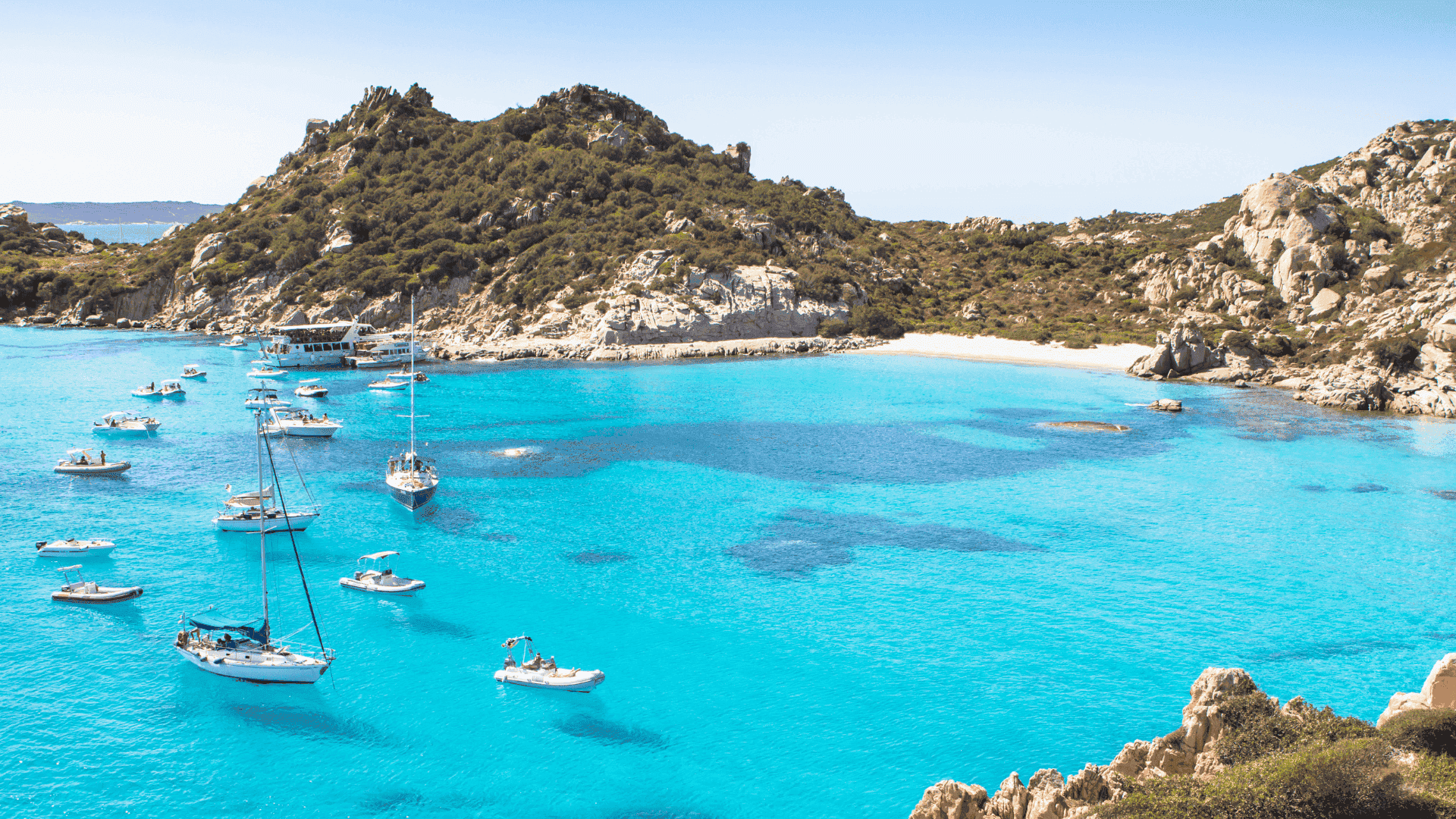 spiaggia di cala corsara sardinia island italy yachts moored bay mountain blue water