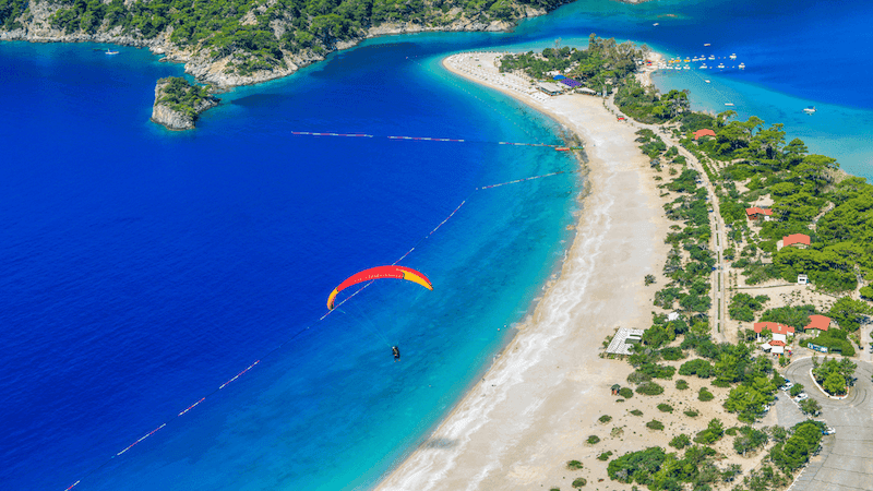 fethiye oludeniz red parachute over beach