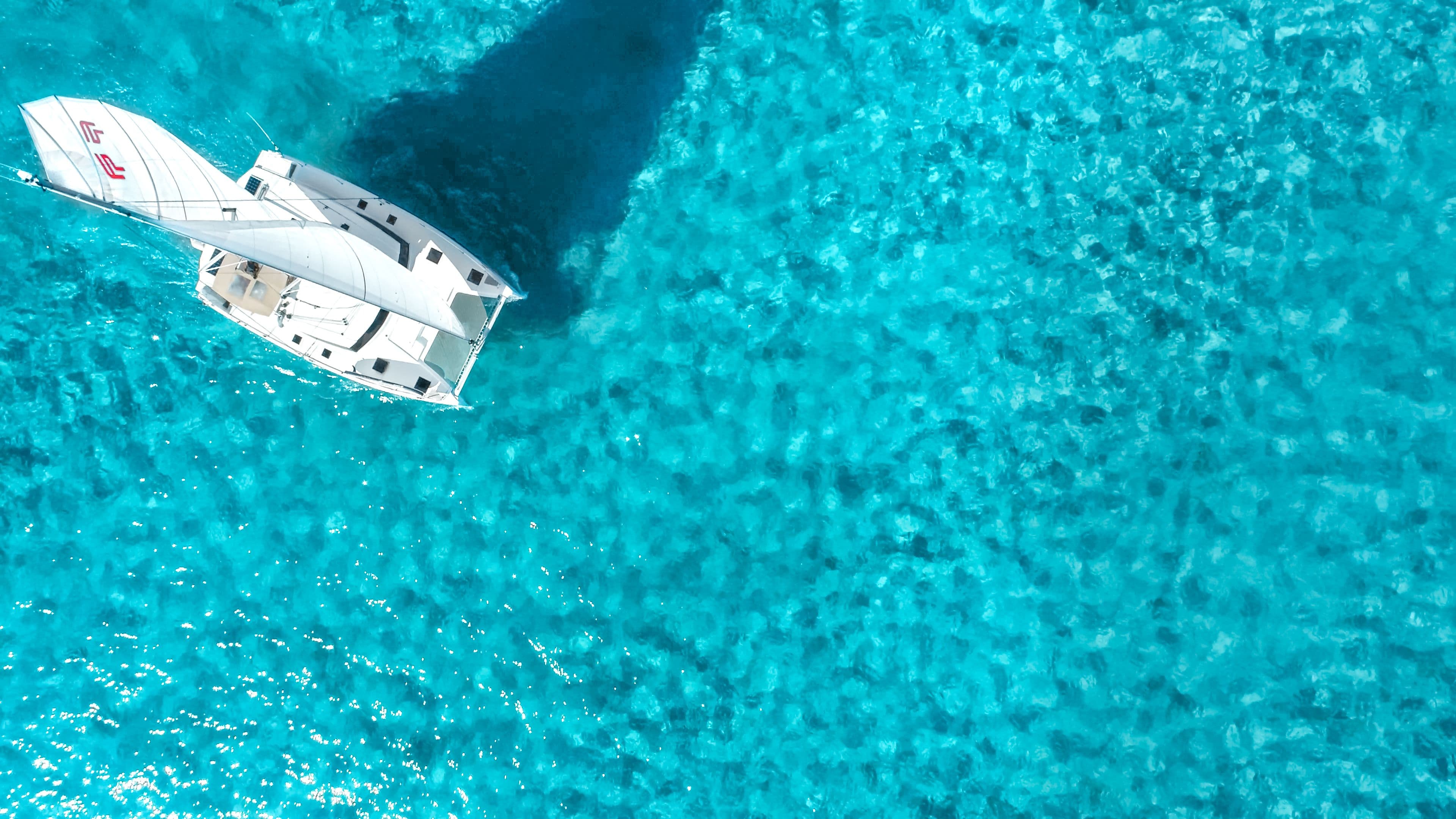 top-down-catamaran-sailing-impossible-blue-bahamas
