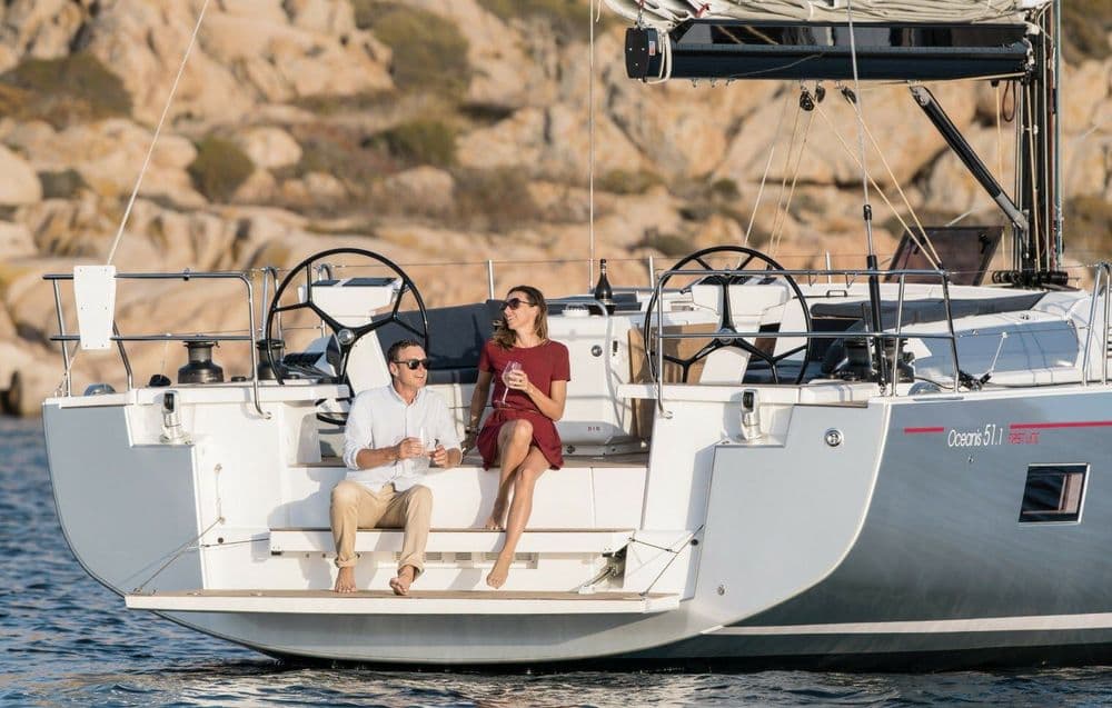 oceanis 51.1 freyja two people sitting on back of boat