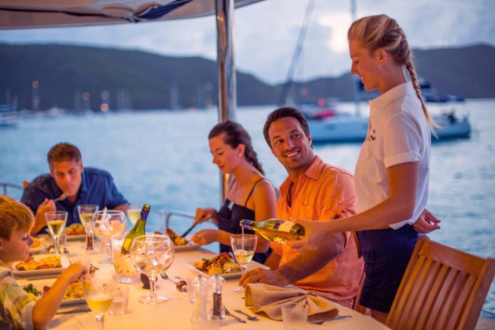 guests being served at dinner crewed yacht