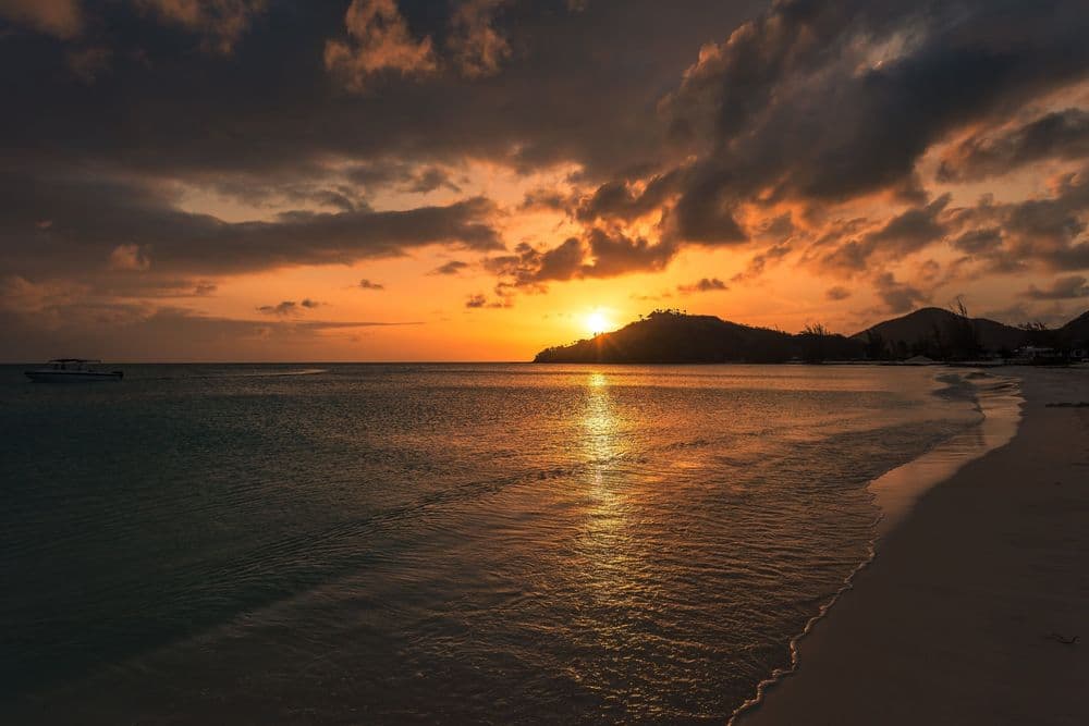sunset behind mountains on antigua beach