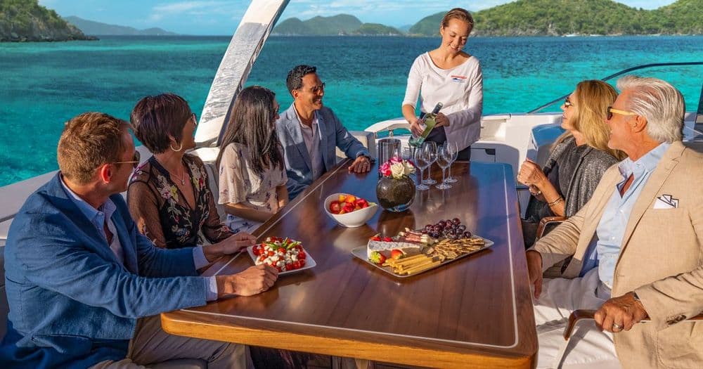 crewed marine max power catamaran bvi caribbean people at table