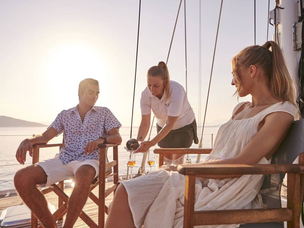 stewardess pouring wine crewed yacht aizu