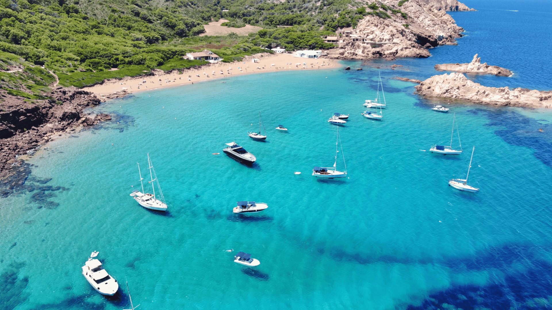 boats anchored in menorca spain blue water