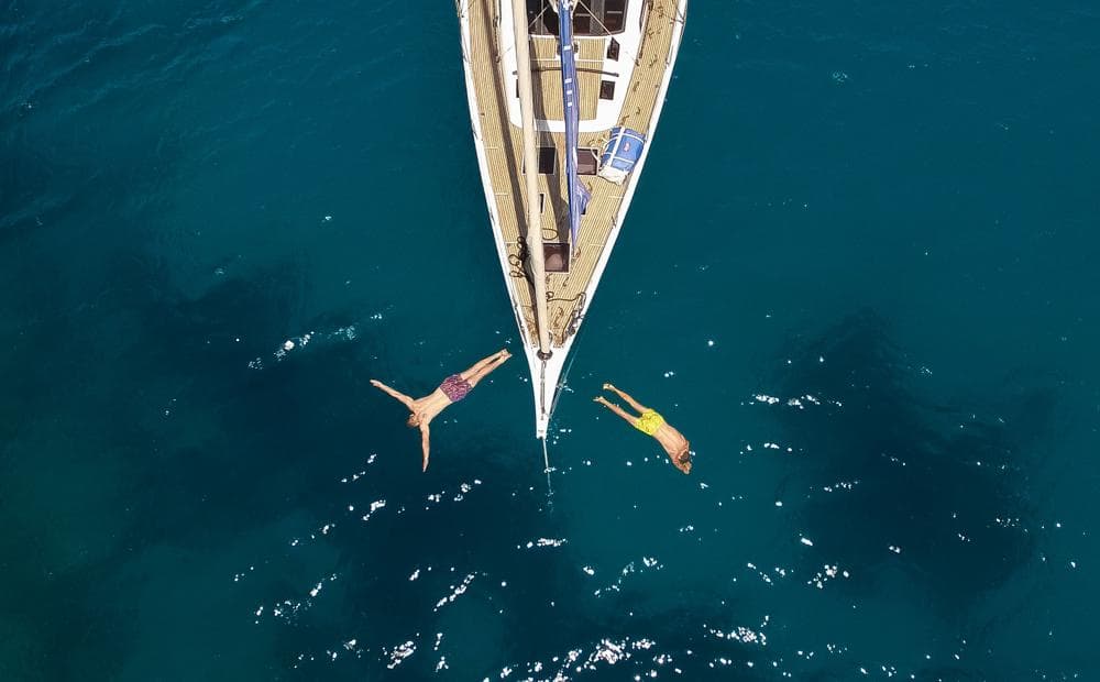 two people diving off bow